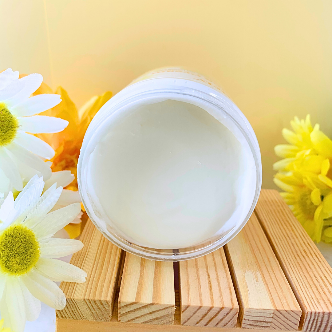 Curly Assembly Sweet Vanilla Curl Defining Cream jar tilted to reveal the smooth, rich texture of the cream inside, ready for moisturizing and defining curls.

