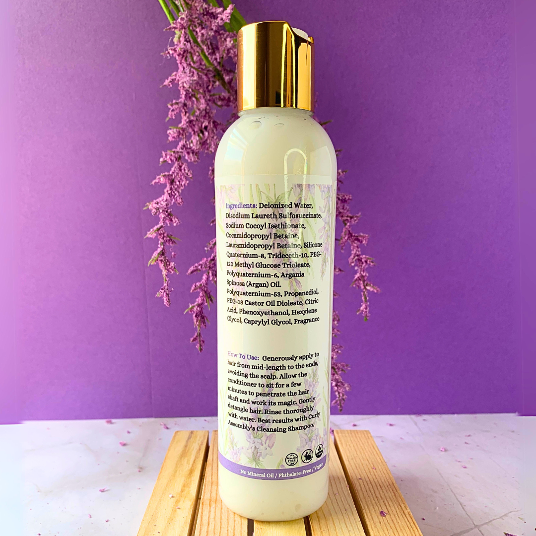 Side view of Curly Assembly Lavender Bliss Conditioner highlighting its moisturizing properties for curly hair.