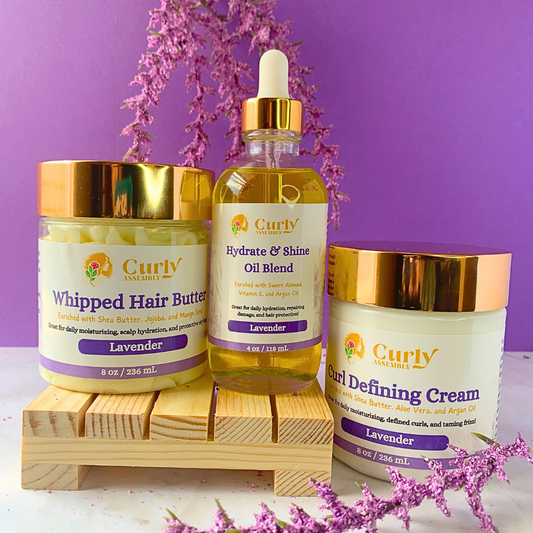 Front-facing image of Curly Assembly Trio Bundle in Lavender Bliss, featuring Whipped Hair Butter, Hydrate & Shine Oil Blend, and Curl Defining Cream.